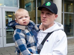 Rogan Christopher with son Max outside a vaccine clinic at UBCon Friday. Max was getting the flu jab after recently recovering from RSV.