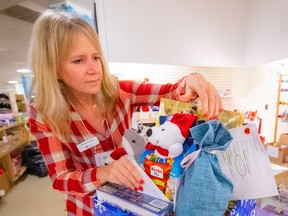 Michelle Varley puts together gift baskets for the North Shore Bureau's Christmas campaign at their North Vancouver office.