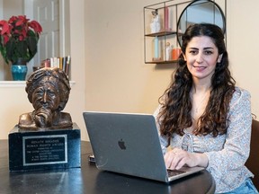 Shanga Karim poses for a photo in her home with the Renata Shearer Human Right Award. Karim is a former Kurdish journalist and refugee and is being honoured for her work. Photo: Richard Lam