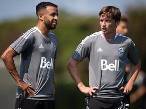 New Vancouver Whitecaps designated player Ryan Gauld, right, of Scotland, stands with Caio Alexandre during an MLS soccer club training session, in Vancouver, B.C., Monday, Aug. 2, 2021. The Vancouver Whitecaps have extended midfielder Caio Alexandre's loan to Fortaleza EC for another year, with an obligation for the Brazilian side to purchase his contract if he hits undisclosed performance benchmarks.