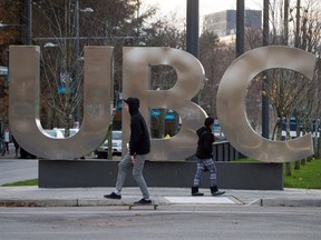 People pass by large letters spelling out UBC at the University of British Columbia in Vancouver on Nov. 22, 2015. Four British Columbia universities will receive $4.3 million from a government research and innovation program to help fund projects in the fields of health, technology and natural resources.
