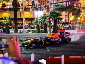 In this file photo taken on November 5, 2022, a Formula 1 car burns out on the Las Vegas Strip during the Las Vegas Grand Prix Launch Party.