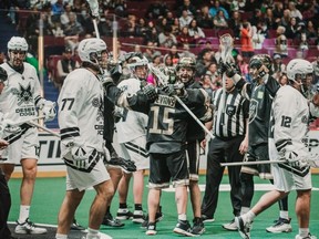 Shawn Evans and Logan Schuss celebrate during the Vancouver Warriors' 19-16 win over the Las Vegas Desert Dogs last Saturday at Rogers Arena.