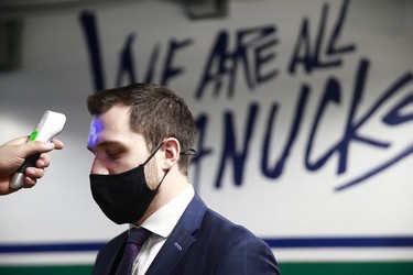 Bo Horvat #53 of the Vancouver Canucks gets a temperature check before their NHL game against the Toronto Maple Leafs at Rogers Arena on March 6, 2021 in Vancouver, British Columbia, Canada.