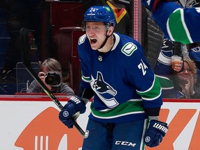 Travis Dermott of the Vancouver Canucks celebrates after scoring during an NHL game against the Ottawa Senators at Rogers Arena on April 19, 2022.