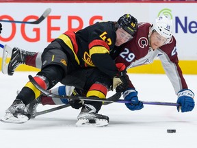 Quinn Hughes uses speed, positioning to check Nathan MacKinnon on Friday at Rogers Arena.