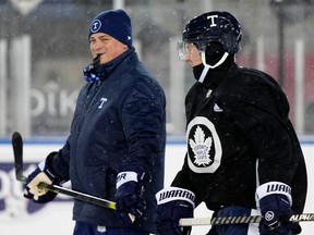 Head coach Sheldon Keefe of the Toronto Maple Leafs skates with Travis Dermott during a family skate at Tim Hortons Field on March 12, 2022 in Hamilton.