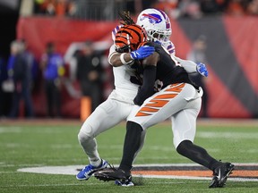Damar Hamlin of the Buffalo Bills (in white) tackles Tee Higgins of the Cincinnati Bengals in the first quarter of their Jan. 2, 2023 NFL game at Paycor Stadium in Cincinnati. Hamlin was stretchered off the field by medical personnel following the play.