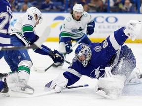 Andrei Vasilevskiy of the Tampa Bay Lightning stops a shot from Bo Horvat of the Vancouver Canucks during an NHL game at Amalie Arena on Jan. 12 in Tampa, Fla.