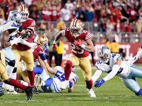 Running back Elijah Mitchell of the San Francisco 49ers carries the ball against the Dallas Cowboys during their NFC Divisional playoff game at Levi's Stadium in Santa Clara, Calif., on Jan. 22, 2023.