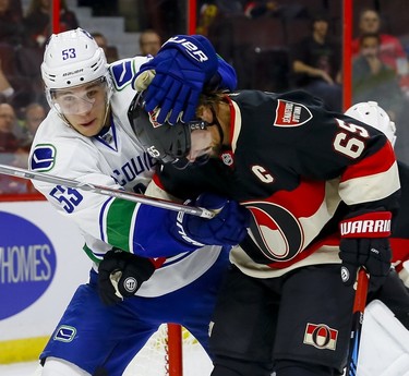 Vancouver Canucks center Bo Horvat (53) roughs up Ottawa Senators defenseman Erik Karlsson (65) at Canadian Tire Centre in Ottawa on Thursday November 3, 2016. Errol McGihon/Postmedia