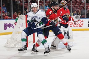 Aaron Ekblad #5 of the Florida Panthers checks Bo Horvat #53 of the Vancouver Canucks during second period action at the BB&T Center on February 6, 2018 in Sunrise, Florida.