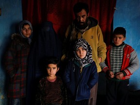 The family of Amrullah, a child who died due to cold, poses for a photograph in their house in Kabul, Afghanistan, Jan. 30, 2023.