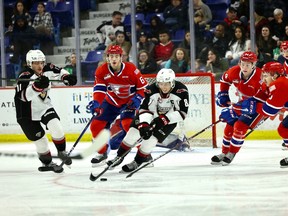 New Vancouver Giants captain Ty Thorpe tries to elude a gaggle of Spokane Chiefs checkers in Friday's 4-2 Spokane win at the Langley Events  Centre.