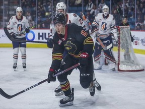 Vancouver Giants centre Ty Thorpe tries to elude Kamloops Blazers defenceman Ethan Brandwood during a WHL game earlier this season in Kamloops. The teams will meet in the first round of the playoffs starting next weekend.