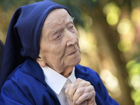 In this file photo taken Feb. 10, 2021, Sister Andre, Lucile Randon in the registry of birth, the eldest French and European citizen, prays in a wheelchair, on the eve of her 117th birthday, in Toulon, France.
