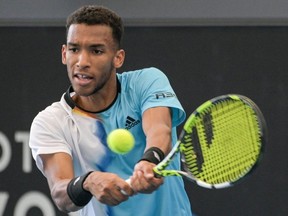 Canada's Felix Auger-Aliassime hits a return against Australia's Alexei Popyrin during their men's singles match at the Adelaide International tennis tournament in Adelaide on January 2, 2023.