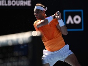 Spain's Rafael Nadal hits a return against Britain's Jack Draper during their men's singles match on day one of the Australian Open tennis tournament in Melbourne on January 16, 2023.