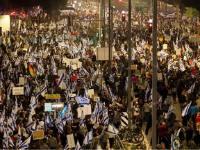 Israelis march in Tel Aviv on January 28, 2023 during a protest against controversial government plans to give lawmakers more control of the judicial system. - Prime Minister Benjamin Netanyahu and his allies, who have formed the most right-wing government in Israel's history, say the reforms are necessary to correct an imbalance that has given judges too much power over elected officials. (Photo by JACK GUEZ / AFP)