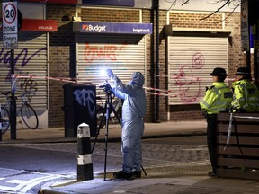 Forensics officer works at the scene of a shooting, the attack reportedly happened during a funeral at St Aloysius Church, in London, Britain, January 14, 2023. REUTERS/Henry Nicholls