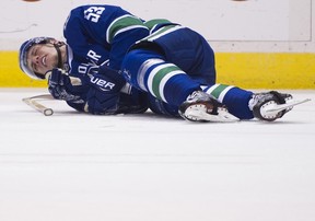 Vancouver Canucks #53 Bo Horvat lays on the ice after a check from the St. Louis Blues during the first period of a regular season NHL hockey game at Rogers Arena, Vancouver, October 18 2016.  ( Gerry Kahrmann  /  PNG staff photo)