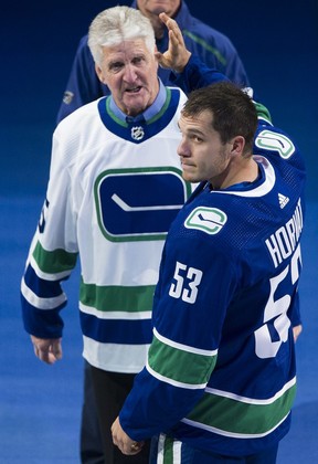 Vancouver Canucks #53 Bo Horvat waves after putting on his captains jersey watched by Orland Kurtenbach at Rogers Arena, Vancouver, October 09 2019.   Gerry Kahrmann  /  PNG staff photo)