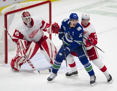 Vancouver Canucks #53 Bo Horvat is pressured by Detroit Red Wings #21 Dennis Cholowski as he tries to clear him from in front of #45 Jonathan Bernier in a regular season NHL hockey game at Rogers arena, Vancouver, October 15 2019.   Gerry Kahrmann
