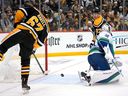 Pittsburgh Penguins' Rickard Rakell (67) puts a shot behind Vancouver Canucks goaltender Spencer Martin (30) for a goal during the second period.