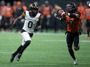 B.C. Lions defensive back Loucheiz Purifoy, right, nearly makes an interception on a pass intended for Hamilton Tiger-Cats' Bralon Addison during the second half of CFL football game in Vancouver, on Thursday, July 21, 2022. The Lions released Purifoy on Wednesday.
