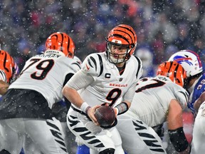Cincinnati Bengals quarterback Joe Burrow gets set to hand the ball off during their AFC divisional round playoff game against the Buffalo Bills in Orchard Park, N.Y., on Jan. 22, 2023.