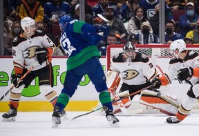 Anaheim Ducks goalie John Gibson (36) stops Vancouver Canucks' Bo Horvat (53) as Anaheim's Kevin Shattenkirk (22) and Isac Lundestrom, of Sweden, watch during the first period of an NHL hockey game in Vancouver, on Tuesday, November 9, 2021.