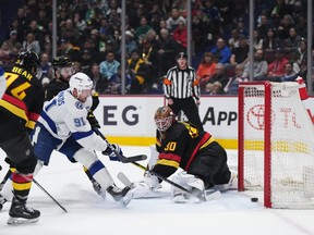 Tampa Bay Lightning's Steven Stamkos (91) scores against Vancouver Canucks goalie Spencer Martin, to record his 501st career goal, during the first period. Stamkos would score three on the night.