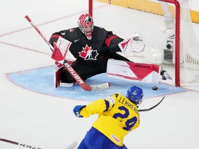 Canada's goaltender Thomas Milic, left, stretches to make a pad save on Sweden's Jonathan Lekkerimaki during second period IIHF World Junior Hockey Championship action in Halifax, Saturday, Dec. 31, 2022.