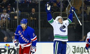 Vancouver Canucks center Bo Horvat (53) reacts after scoring a goal as New York Rangers center Brett Howden (21) skates away during the first period at Madison Square Garden. Mandatory Credit: Andy Marlin-USA TODAY Sports