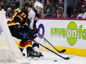 Vancouver Canucks defenseman Oliver Ekman-Larsson (23) checks Columbus Blue Jackets forward Patrik Laine (29) in the second period at Rogers Arena on Jan. 27, 2023.