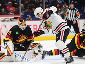 Vancouver Canucks goaltender Collin Delia (60) defends against Chicago Blackhawks forward Taylor Raddysh (11) during the first period at Rogers Arena Jan. 24, 2023.