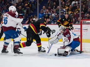 Colorado Avalanche defenseman Jacob MacDonald watches as goalie Alexandar Georgiev makes a save Vancouver Canucks forward J.T. Miller in the first period at Rogers Arena Jan. 20, 2023.