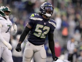 Seattle Seahawks defensive end Darrell Taylor (52) celebrates a defensive stop against the -n- during the second half of an NFL football game, Sunday, Jan. 1, 2023, in Seattle.