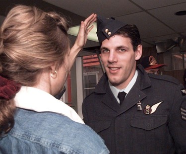 Gino Odjick gets his WW2 Canadian airman's cap set to the proper jaunty angle before he leaves 'wardrobe' to take part in the photo session that will produce this year's Canucks team poster in this Oct. 10, 1995, photo.
