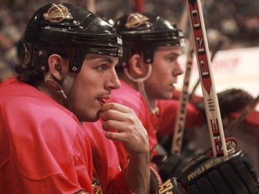 Vancouver Canuck's Gino Odjick and Trevor Linden watch from the bench on Feb. 7, 1996.