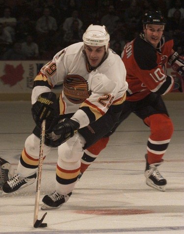 Canucks Gino Odjick and Devils Dennis Pederson on the ice Dec. 18, 1996.
