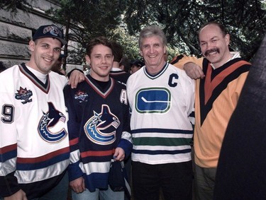 Then-new Canucks uniforms modelled by Gino Odjick and Pavel Bure, along with former team members Orland Kurtenbach and Harold Snepsts in old time uniforms at their official unveiling.