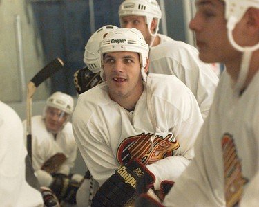 Canucks forward Gino Odjick gives his trademark toothless smile during a training-camp session in Whistler.