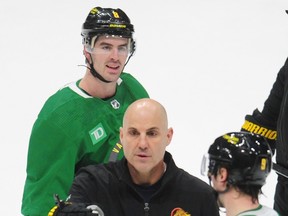 Canucks winger Conor Garland (top) looks on as new head coach Rick Tocchet — Garland's former bench boss in Arizona — run his first Canucks practice on Monday at Rogers Arena.