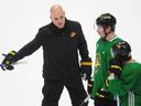 New Canucks head coach Rick Tocchet gives some direction to forward J.T. Miller during Tocchet's first practice with the team on Monday at Rogers Arena.