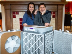 Roger and Jeni Haskett (at left) with District Parent Advisory Council vice-chair Kyenta Martins and do-it-yourself air purifiers in Vancouver, BC, January 18, 2023. Roger and Jeni Haskett have made several Corsi-Rosenthal boxes, which are do-it-yourself air purifiers. The Hasketts and other Vancouver parents, such as District Parent Advisory Council vice-chair Kyenta Martins, would like the Vancouver school board to allow the boxes in classrooms to improve air quality.