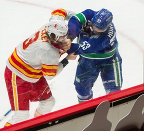 Vancouver Canucks  Bo Horvat fights Calgary Flames Connor Mackey during NHL action at Rogers Arena in Vancouver, BC, May 18, 2021. 

Photo by Arlen Redekop / Vancouver Sun / The Province (PNG)