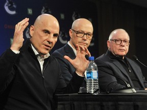 New Canucks head coach Rick Tocchet (left) with GM Patrik Allvin (middle) and team president Jim Rutherford at their Sunday news conference at Rogers Arena.