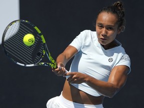 Leylah Fernandez of Canada plays a backhand return to Alize Cornet of France during their first-round match at the Australian Open tennis championship in Melbourne, Australia, Tuesday, Jan. 17, 2023.