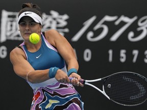 Bianca Andreescu of Canada plays a backhand return to Marie Bouzkova of the Czech Republic during their first round match at the Australian Open tennis championship in Melbourne, Australia, Monday, Jan. 16, 2023.